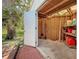 Shed interior with plywood walls, lighting, shelving, tools and supplies at 11362 Heritage Way, Largo, FL 33778