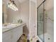 Bathroom with a glass shower door and a large mirror at 11439 Golf Round Dr, New Port Richey, FL 34654