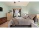 Inviting bedroom with soft lighting, a queen-sized bed, and a sliding glass door to the patio at 11439 Golf Round Dr, New Port Richey, FL 34654