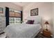 Comfortable bedroom featuring a queen bed with neutral bedding and ample natural light at 11439 Golf Round Dr, New Port Richey, FL 34654