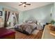 Relaxing bedroom with light green walls, a ceiling fan, and a queen-sized bed at 11439 Golf Round Dr, New Port Richey, FL 34654