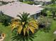 Landscaped lawn with mature palm trees surrounds this home, offering scenic views at 11439 Golf Round Dr, New Port Richey, FL 34654