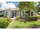 Home with a screened in patio and lush landscaping at 11439 Golf Round Dr, New Port Richey, FL 34654