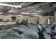 Well-equipped gym with modern treadmills, exercise bikes, weight machines and a TV at 11439 Golf Round Dr, New Port Richey, FL 34654