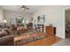 Inviting living room features hardwood floors, a ceiling fan, and lots of natural light at 11439 Golf Round Dr, New Port Richey, FL 34654