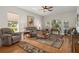 Living room displays hardwood floors, comfortable seating, and arch windows at 11439 Golf Round Dr, New Port Richey, FL 34654