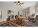 Open living area with hardwood floors, comfortable leather furniture, and a flat screen TV at 11439 Golf Round Dr, New Port Richey, FL 34654