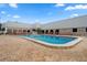 Inviting community swimming pool surrounded by brick pavers and lounge chairs on a bright day at 11439 Golf Round Dr, New Port Richey, FL 34654