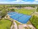 Overhead view of community recreation area with tennis and basketball courts, playground, and green space at 11830 Autumn Creek Dr, Riverview, FL 33569