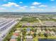 Enjoy this aerial view of a residential area with lush greenery under a blue sky at 11830 Autumn Creek Dr, Riverview, FL 33569