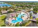 An aerial view showcases a community pool, tennis courts, and lush greenery, perfect for active living at 11830 Autumn Creek Dr, Riverview, FL 33569