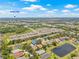 Beautiful aerial view of Tampa Bay neighborhood featuring a serene pond and lush greenery at 11830 Autumn Creek Dr, Riverview, FL 33569