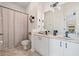 Bathroom featuring double sinks with a shared vanity, a toilet, and a shower with a curtain at 11830 Autumn Creek Dr, Riverview, FL 33569