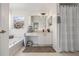 Well-lit bathroom featuring a soaking tub, a vanity area with ample counter space, and neutral-toned decor at 11830 Autumn Creek Dr, Riverview, FL 33569
