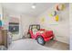 Bright bedroom featuring playful Jeep bed, beach ball decor, and ample natural light at 11830 Autumn Creek Dr, Riverview, FL 33569