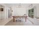 Open-concept dining room with a large table, white chairs, and view to the kitchen at 11830 Autumn Creek Dr, Riverview, FL 33569