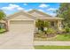 Charming single-Gathering home with well-manicured lawn and an attached two-car garage at 11830 Autumn Creek Dr, Riverview, FL 33569