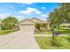 Beautiful single-story home featuring a well-kept lawn, front garden, and an attached two-car garage at 11830 Autumn Creek Dr, Riverview, FL 33569