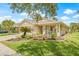 A lovely one-story home with a pristine lawn and a beautiful small palm tree in the front yard at 11830 Autumn Creek Dr, Riverview, FL 33569