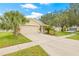A one-story home with a well-manicured lawn, sidewalk, and a spacious driveway leading to an attached garage at 11830 Autumn Creek Dr, Riverview, FL 33569