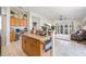 Bright kitchen features wooden cabinetry, an island and an open view to the living area and backyard at 11830 Autumn Creek Dr, Riverview, FL 33569