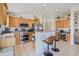 Spacious kitchen featuring light wood cabinets, stainless steel appliances, and a convenient breakfast bar at 11830 Autumn Creek Dr, Riverview, FL 33569