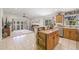 Bright kitchen featuring wooden cabinetry, an island and an open view to the living area and backyard at 11830 Autumn Creek Dr, Riverview, FL 33569