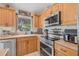 Kitchen area showcases wood cabinets, modern appliances, and natural light at 11830 Autumn Creek Dr, Riverview, FL 33569