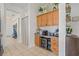 Butler's pantry with wooden cabinets, beverage cooler, and decor, seamlessly connecting to other areas at 11830 Autumn Creek Dr, Riverview, FL 33569