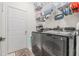 Well-organized laundry room with modern washer and dryer, plus ample storage shelves at 11830 Autumn Creek Dr, Riverview, FL 33569