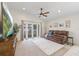Bright living room featuring a ceiling fan, a leather sofa, and access to the outdoors through sliding glass doors at 11830 Autumn Creek Dr, Riverview, FL 33569