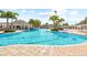 Resort-style pool featuring comfortable lounge chairs and lush tropical landscaping at 11830 Autumn Creek Dr, Riverview, FL 33569