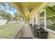 Screened porch features ceiling fans, outdoor seating, and views of the backyard at 11830 Autumn Creek Dr, Riverview, FL 33569