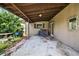 Covered back porch area, featuring a concrete floor and access to the home at 1213 Cuttingin Pl, Tampa, FL 33612
