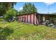 Backyard view with various items and partial view of the home's exterior at 1213 Cuttingin Pl, Tampa, FL 33612