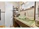 Bathroom sink with glass bowl, surrounded by glass countertop and dark wooden vanity at 1213 Cuttingin Pl, Tampa, FL 33612