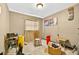 A small bedroom with tan walls has miscellaneous items scattered across the floor at 1213 Cuttingin Pl, Tampa, FL 33612