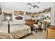 Bedroom with many pictures and paintings on the walls has desk in the center of the room at 1213 Cuttingin Pl, Tampa, FL 33612