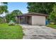 Exterior view of a home with a covered parking area and front yard at 1213 Cuttingin Pl, Tampa, FL 33612