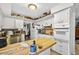 Bright kitchen with wooden island, white cabinetry, and classic appliances at 1213 Cuttingin Pl, Tampa, FL 33612