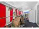 Enclosed patio with drop cloth style curtains, is full of cardboard boxes and other junk at 1213 Cuttingin Pl, Tampa, FL 33612