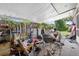 Covered patio is full of junk, miscellaneous equipment, boxes and an old wheelbarrow at 1213 Cuttingin Pl, Tampa, FL 33612
