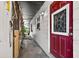 Side entrance featuring a red door with a decorative glass window and a covered walkway at 1213 Cuttingin Pl, Tampa, FL 33612