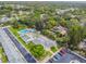 An aerial view of community amenities featuring a pool, shuffleboard, parking and lush landscaping at 12400 Park Blvd # 519, Seminole, FL 33772