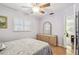 Light, airy bedroom with wood flooring, a ceiling fan, a dresser with mirror, and a shuttered window at 12400 Park Blvd # 519, Seminole, FL 33772