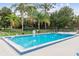Enjoy the community pool surrounded by lush landscaping and seating at 12400 Park Blvd # 519, Seminole, FL 33772
