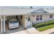 Close up of the front entrance of a charming villa with an adjacent carport and well maintained landscaping at 12400 Park Blvd # 519, Seminole, FL 33772