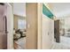 Hallway view of a living room with comfortable seating, leading to the kitchen area with modern appliances at 12400 Park Blvd # 519, Seminole, FL 33772