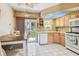 Well-equipped kitchen with wooden cabinets, stylish backsplash, and a ceiling skylight at 12400 Park Blvd # 519, Seminole, FL 33772