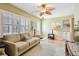 Cozy living room featuring a plush sofa, bright windows, and a ceiling fan at 12400 Park Blvd # 519, Seminole, FL 33772